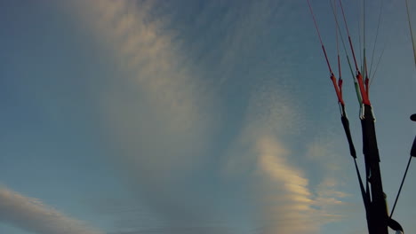 paragliding gear against a cloudy sky