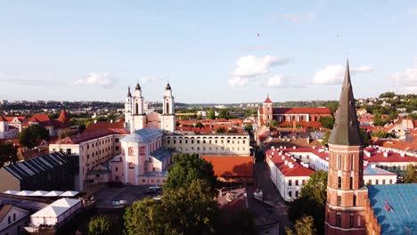 kaunas city old town aerial drone shot while the drone is flying backwards revealings beautiful church towers