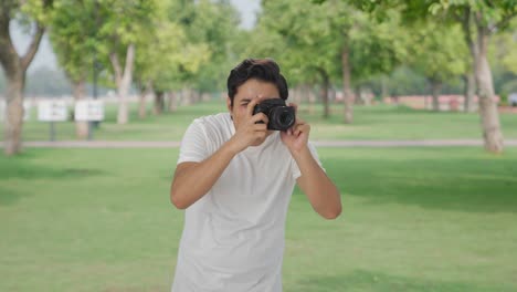 Indian-man-clicking-photos-using-camera