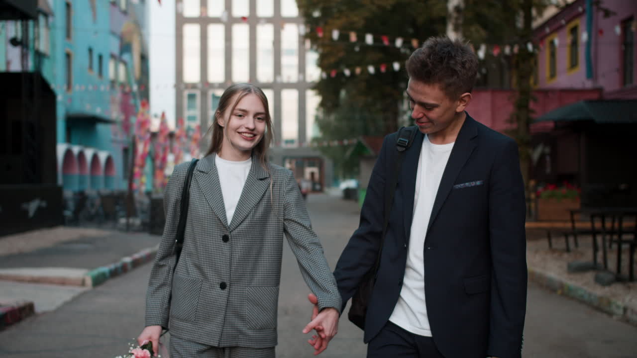 Teenage boy and girl holding hands