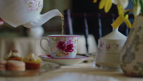 pan across table as tea cup is filled with tea