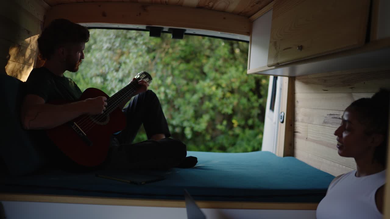 Couple enjoys van life with music and nature