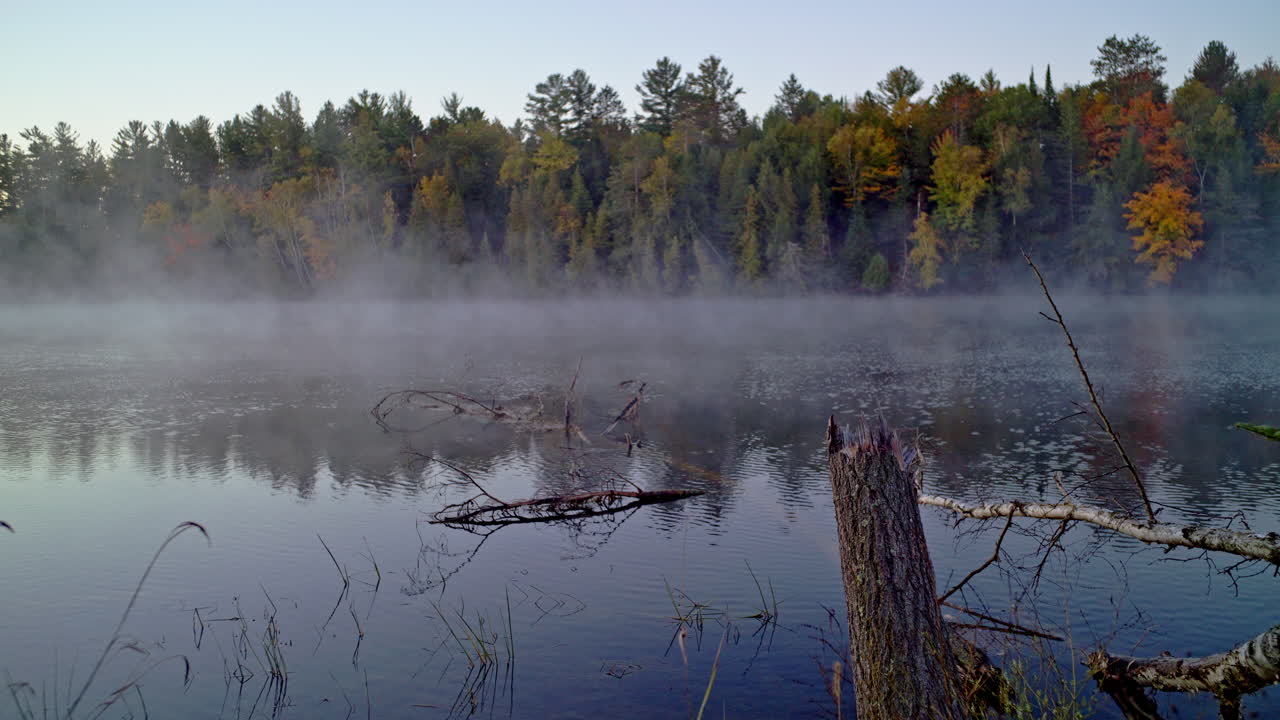 Cinematic shot of morning mist rising off the ausable river at dawn