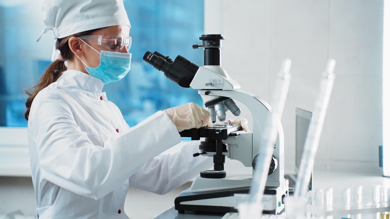 研究室で微鏡を使っている科学者