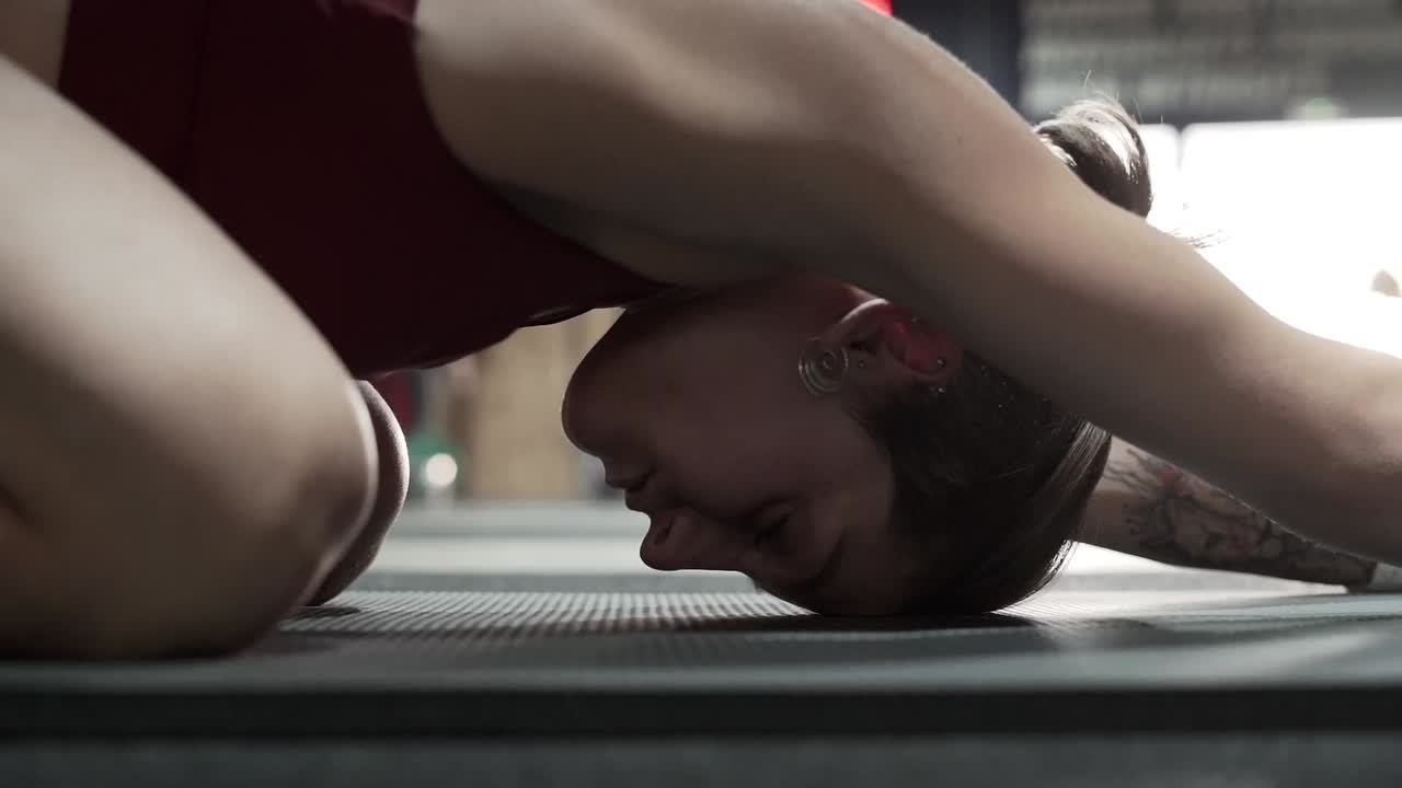 Woman Stretching in a Yoga Pose at the Gym