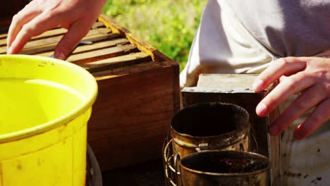 Beekeeper-preparing-bee-smoker-on-truck