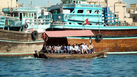 abras negotiate the waters of the dubai creek in the old town dubai in this middle eastern city.