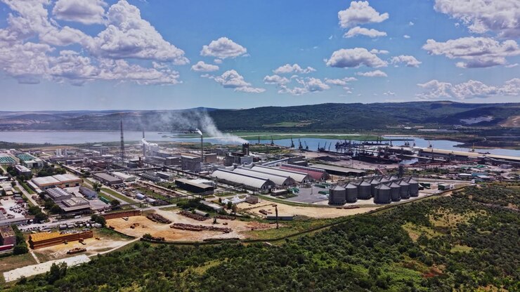Factory complex and waterfront area with clouds in the sky
