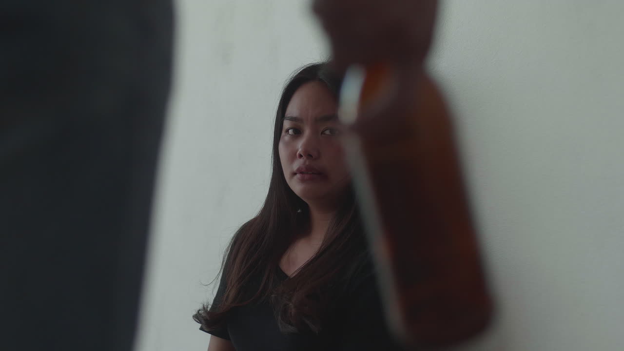 Woman Scared Of A Man Holding A Bottle