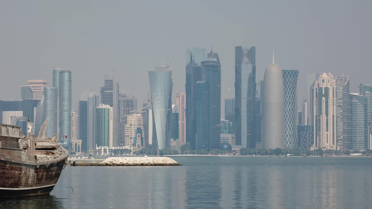 Doha city skyline with skycrapers and boat in marina