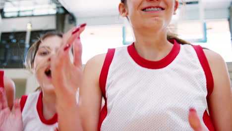 Portrait-Of-Competitive-Female-High-School-Basketball-Team-With-Coach-On-Court