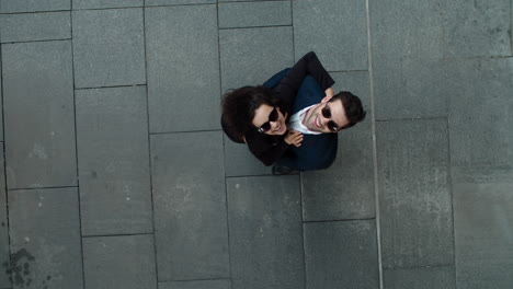 top view couple hugging at street. business couple smiling together outside