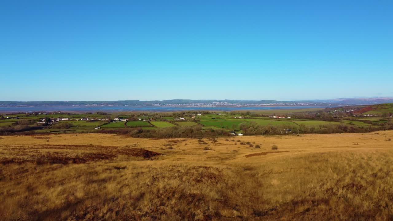 Rising Aerial View of Natural Gower Peninsula Landscape with Loughor Estuary in Background with Surrounding Rural Farmland. Travel Drone Nature Clip