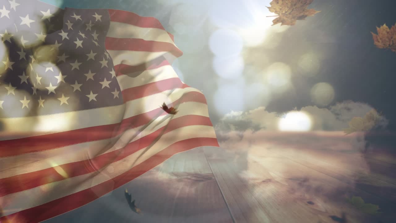 Kompositbild av viftande amerikansk flagga över ljusfläckar mot fallande lönnlöv och blå himmel
