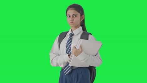 Portrait-of-Confident-Indian-school-girl-standing-with-books-Green-screen