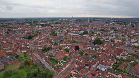 Aerial-shot-of-Bruges-in-Belgium-overlooking-the-city-center-and-it's-churches