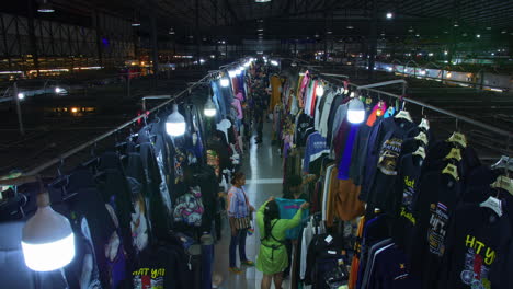 people shopping in busy nightly marketplace bazaar, hat yai, thailand