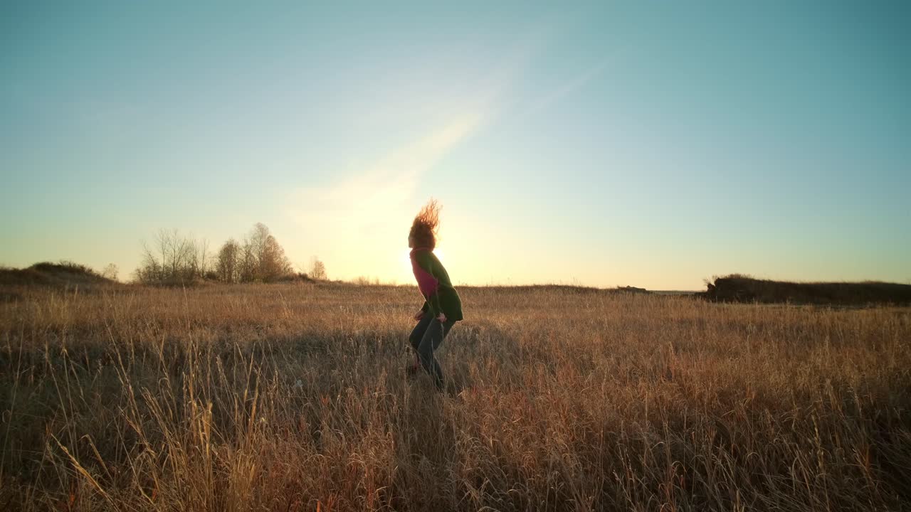 Woman Dancing in a Golden Field at Sunset