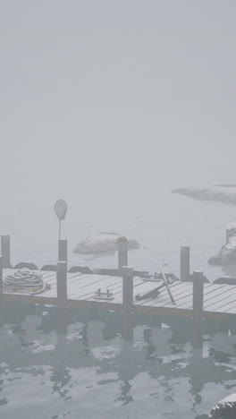 foggy winter lake scene with a dock