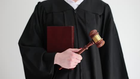 a judge holding a gavel and a law book
