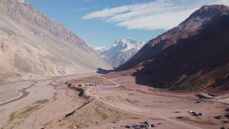 andes mountains with tourists camping near termas valle de colina in chile