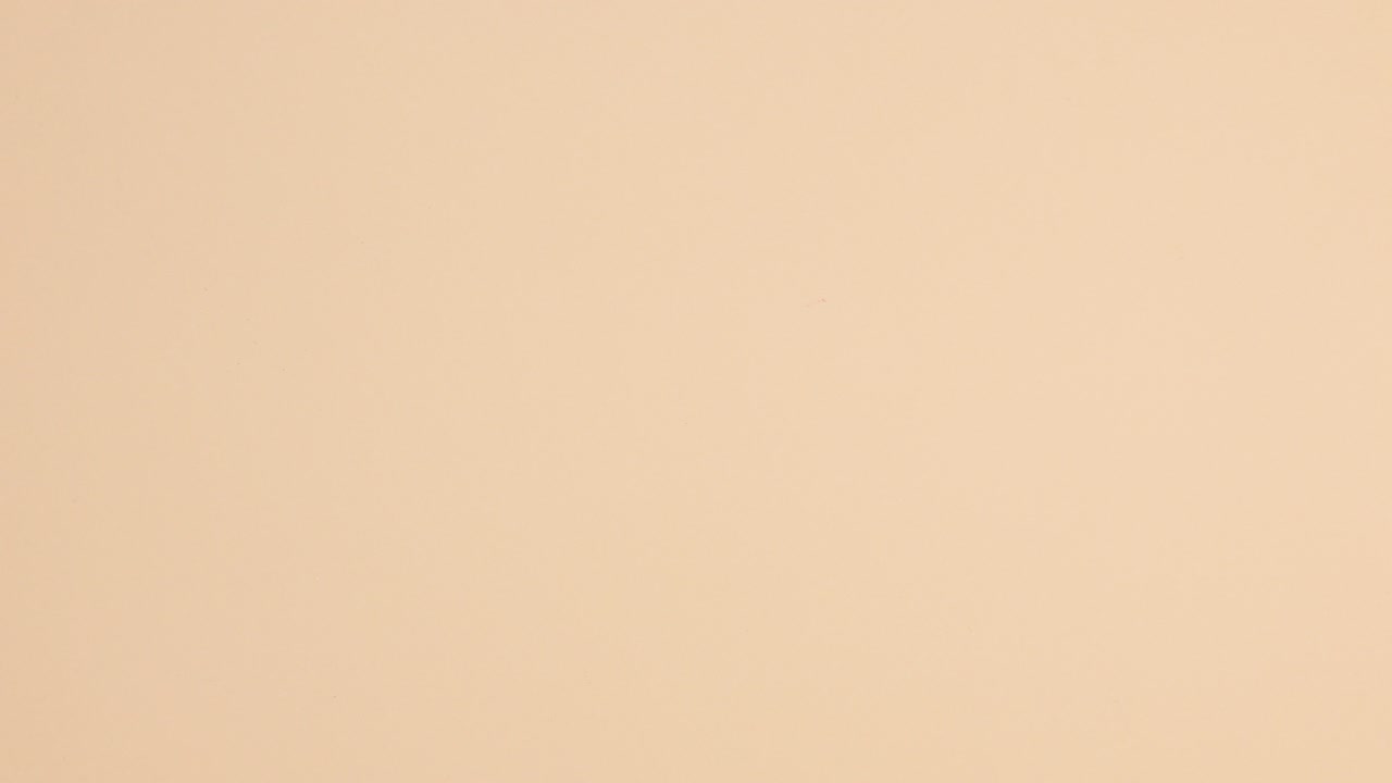 las botellas de esmalte de uñas caen sobre un fondo beige.