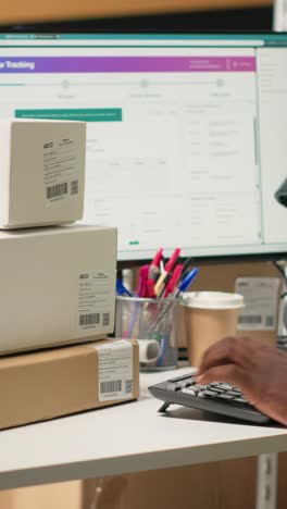 vertical video african american clerk uses barcode scanner to register shipment details tags