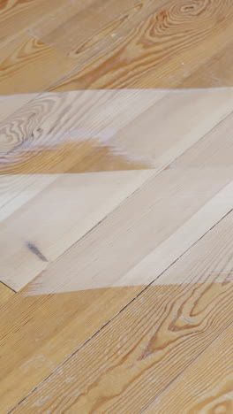 industrial sanding machine working on pine floor surface indoors, vertical format