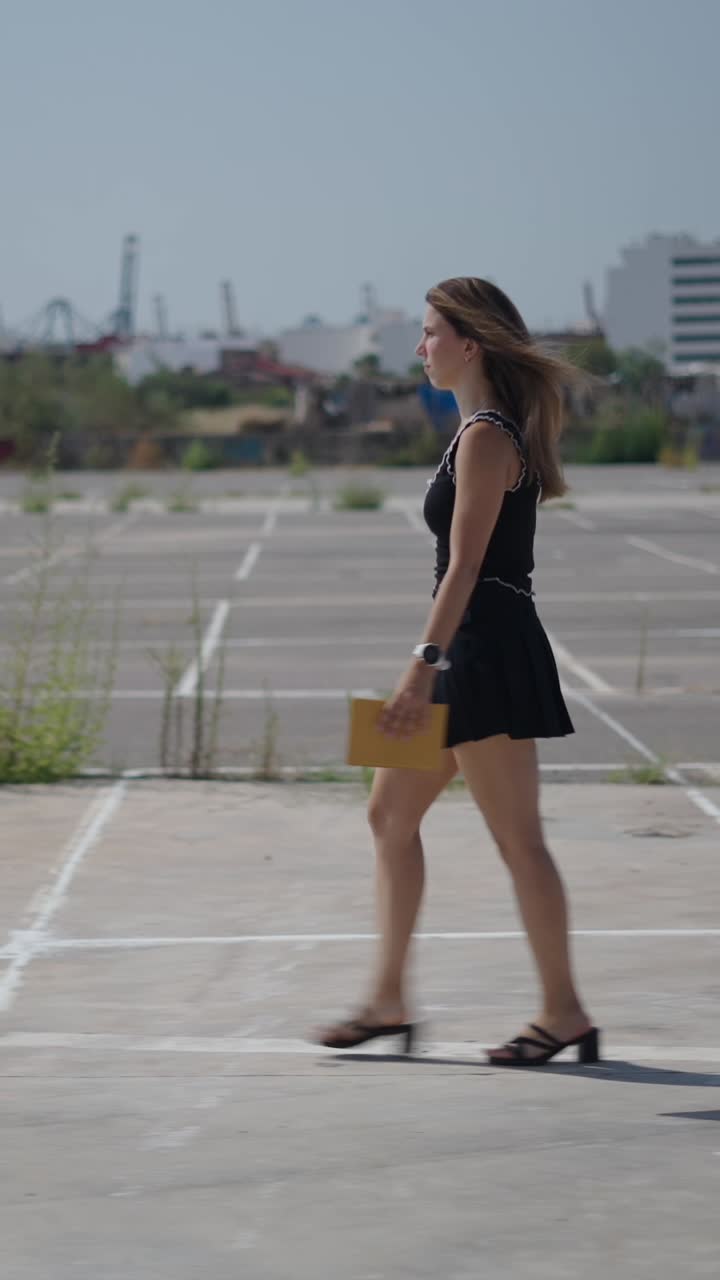 Woman walking in an urban parking lot