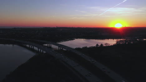 an aerial view over a parkway during sunset with a drone camera