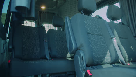 Beautiful-slow-motion-shot-of-the-seats-inside-a-large,-elegant-and-modern-black-van-Mercedes-for-transporting-musical-bands-in-Madrid