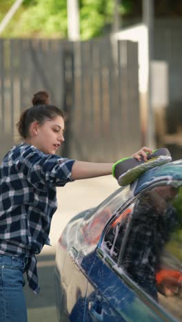 woman washing a blue car