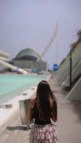 woman walking past modern architecture