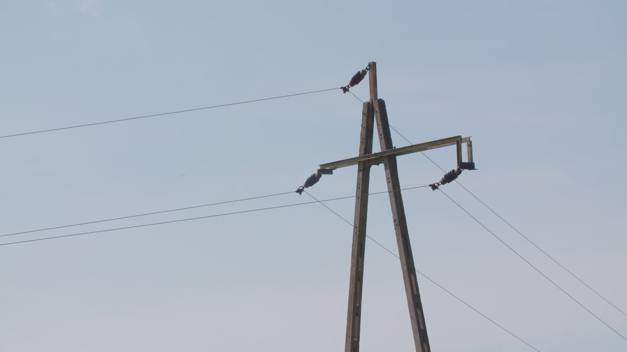 Electricity Pylon At Farm Against Clear Sky