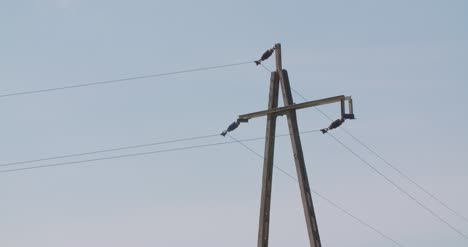 electricity pylon at farm against clear sky