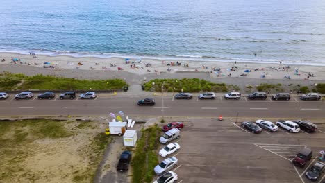 Aerial-sliding-view-along-busy-beachside-road-with-traffic-during-weekends