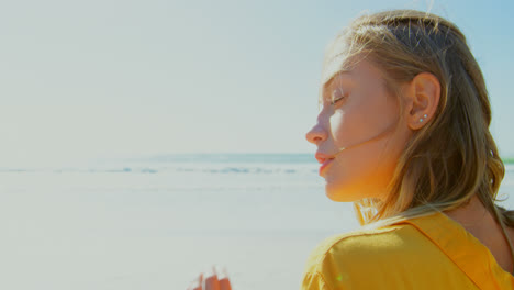 rear view of young caucasian woman relaxing on the beach 4k