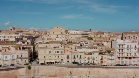 aerial view of ortigia island. flying up above historic old town buildings built on natural fortress by mediterranean sea. unesco world heritage site in sicily.
