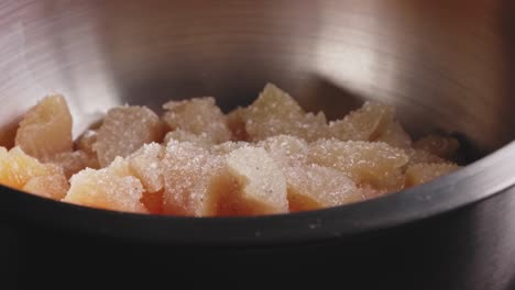 uncooked chicken breast in a bowl with spices and olive oil