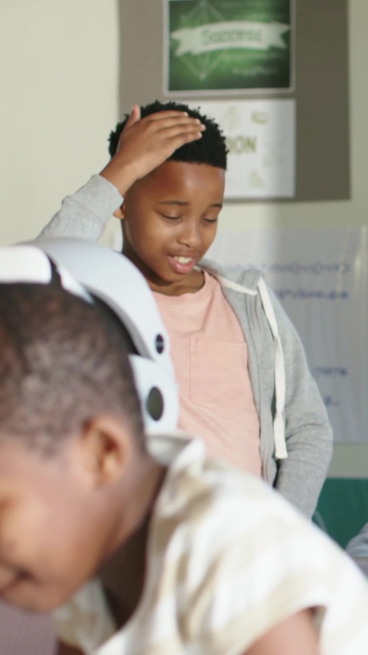 Putting on white VR headset VR user reaching, exploring VR, striped-tee student leaning, copy space