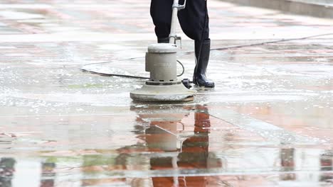 man operating an industrial floor cleaning machine