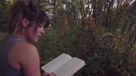 cute hipster girl relaxing in a park and reading a book