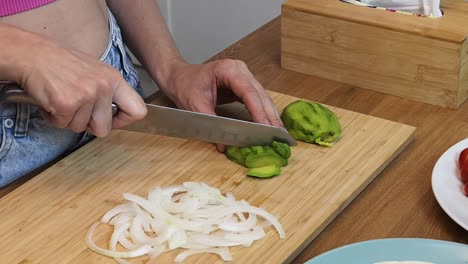 woman chopping avocado and onion