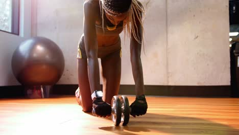 fit woman exercising with dumbbell