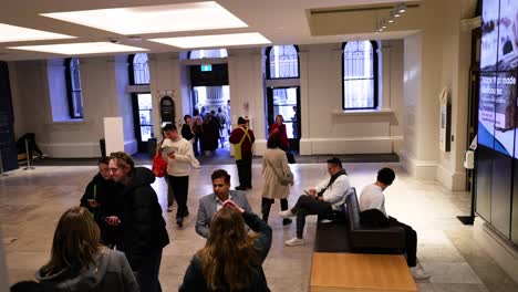 people interacting in a library lobby