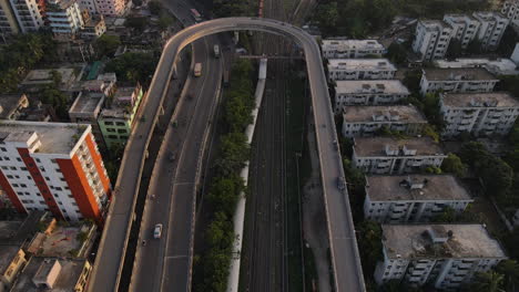 highway loop flyover intersection with rail line between city building