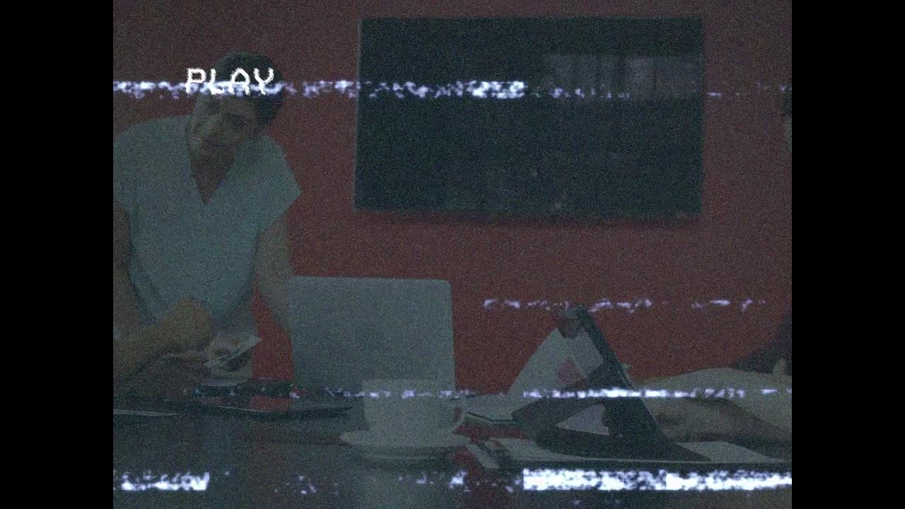 Animation of play screen over talking business people