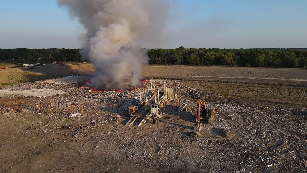 Wide drone video of burning garbage in Woodland Meadows Landfill in Romulus, MI, USA
