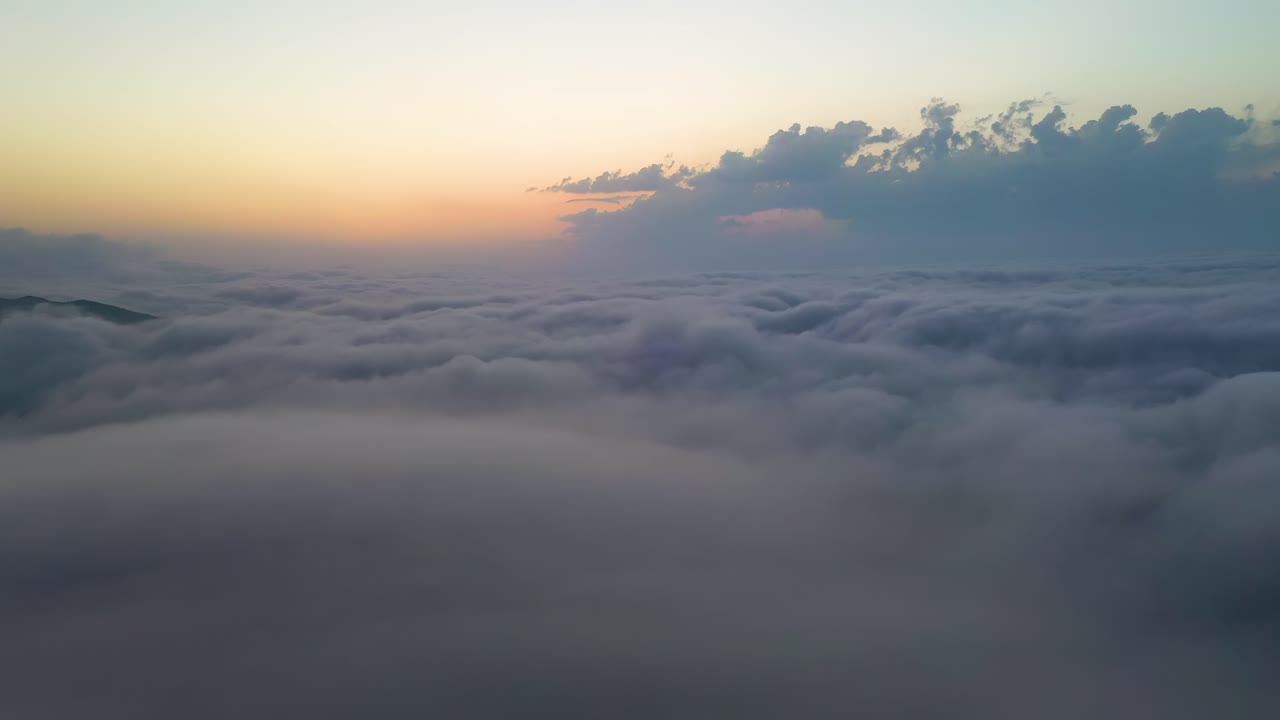 Flying over the clouds with the late sun. Sunrise or sunset colorful sky background.