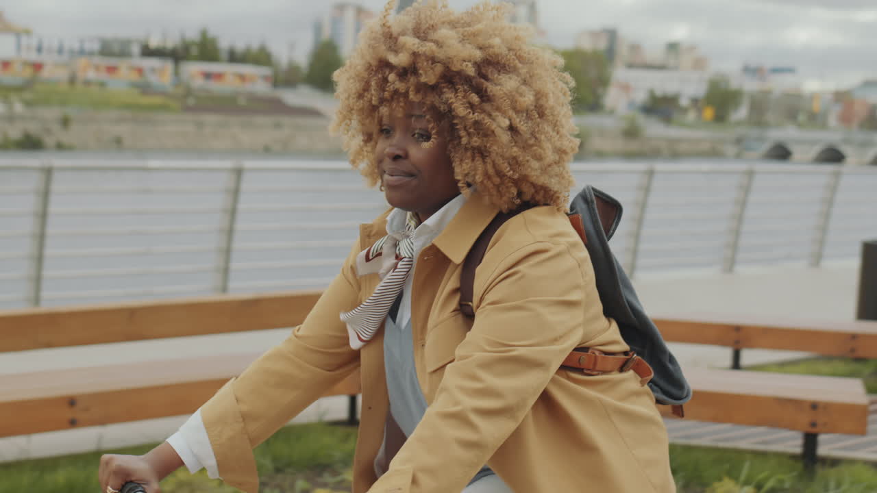 Young African American Woman Riding Bike in City
